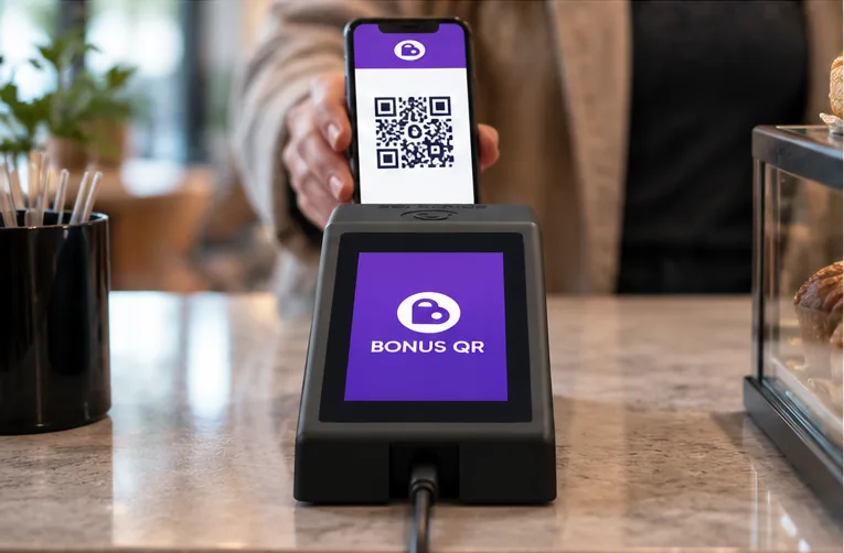 A customer scans a loyalty QR code at a café counter.