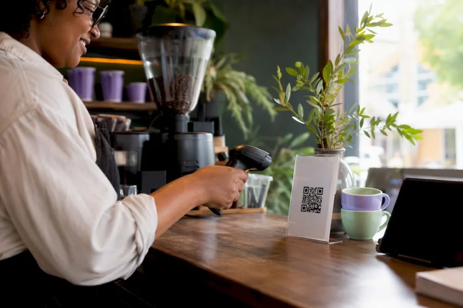 Barista scanning loyalty QR code on coffee receipt