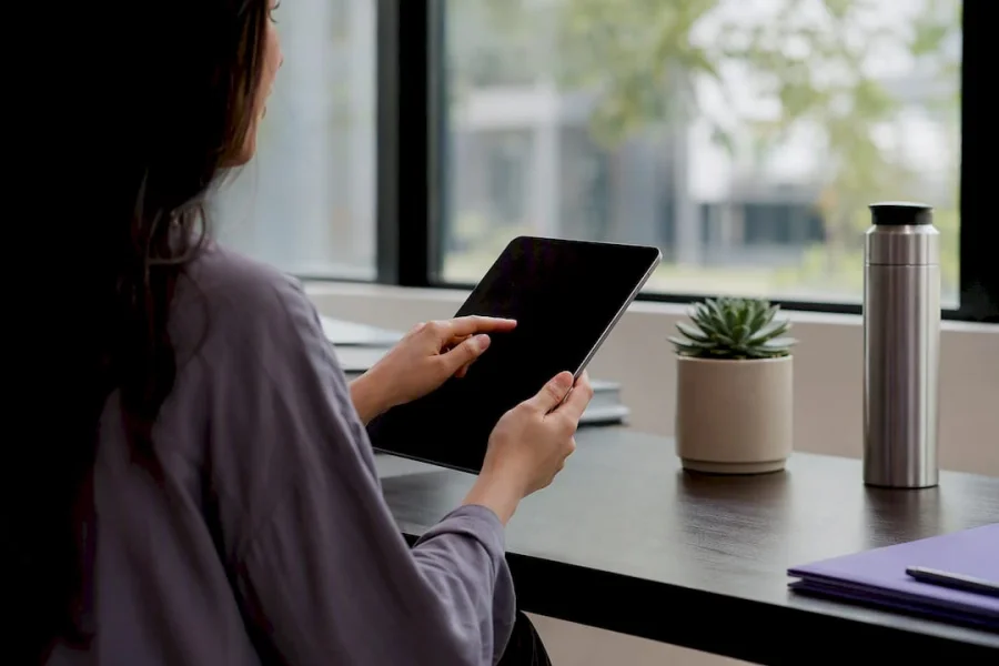 Hands adjusting loyalty settings on tablet