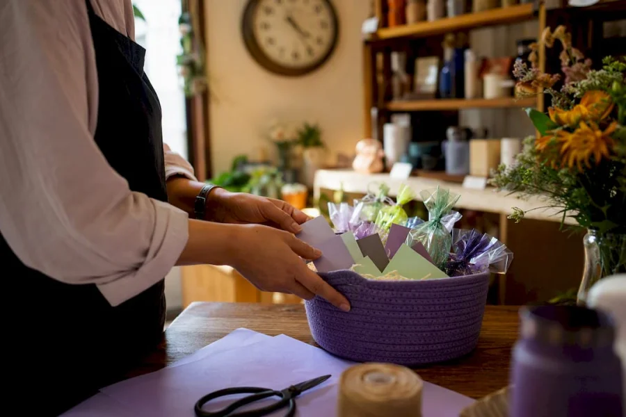 Hands assembling loyalty rewards gifts at retail counter