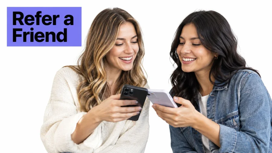 Two happy women smiling while looking at their smartphones together in a bright, modern indoor setting.